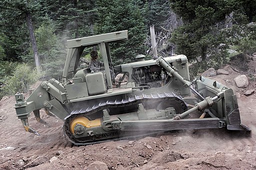 bulldozer digs a trench for forest fire