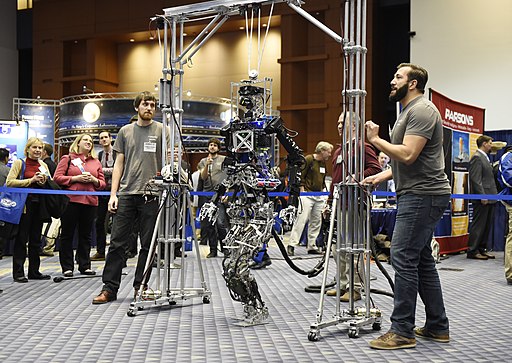 students demonstrating the abilities of a robot