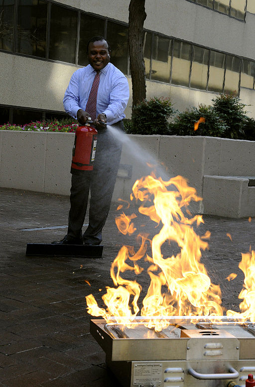 an officer extinguishing a fire