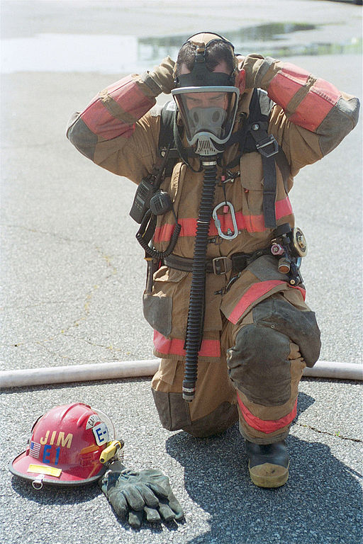 firefighter prepares his gear