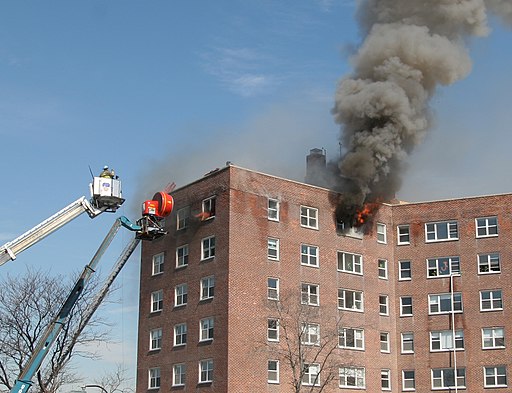 firefighters observing a fire in a high-rise building