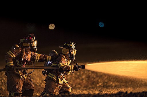 firefighters putting out a fire during a live fire training