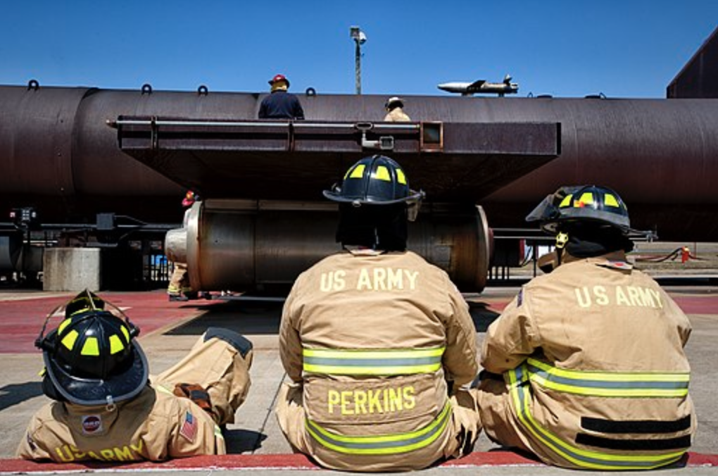soldiers sitting in front of a fire academy