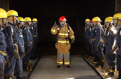a firefighting school trainer giving instructions to students
