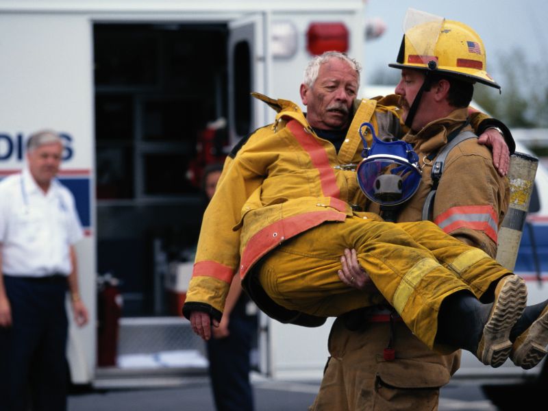 firefighter rescuing another firefighter