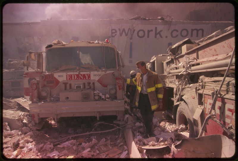 a fire inspector near a damaged fire truck of FDNY New York's Bravest