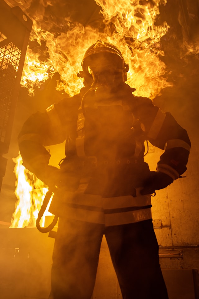 Firefighter standing near a fire