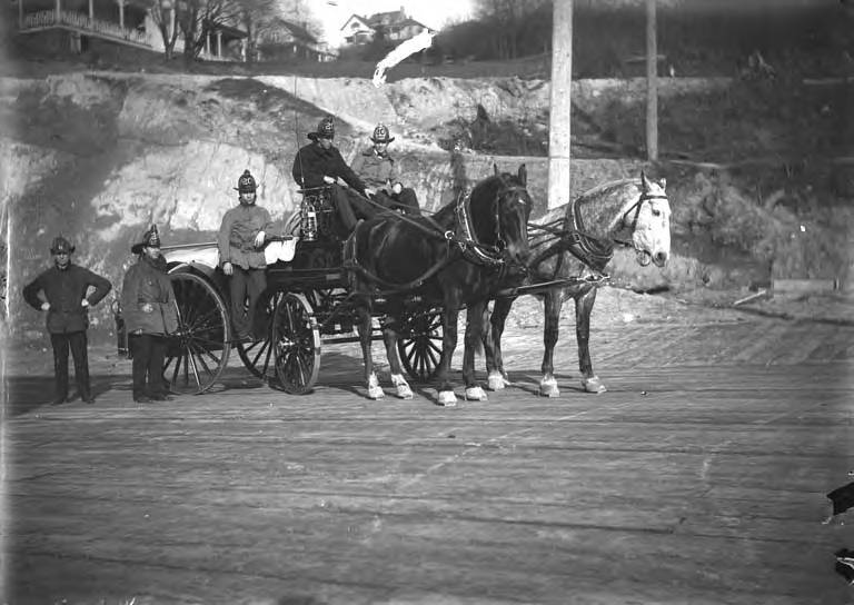 firefighters on a horse-drawn wagon